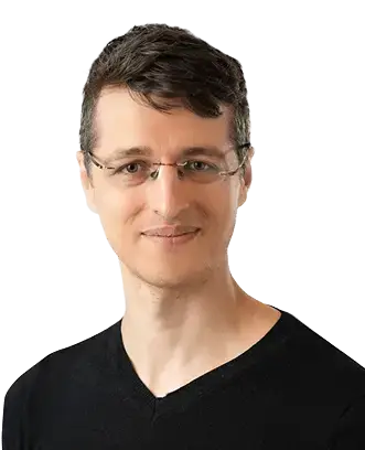 A man wearing glasses and a black shirt, looking directly at the camera with a neutral expression.